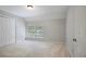 Cozy bedroom featuring neutral carpeting, a large window, and a spacious closet at 963 Bolingbrook Sw Dr, Marietta, GA 30064