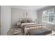 Cozy bedroom featuring neutral decor, carpet, and a large window for natural light at 963 Bolingbrook Sw Dr, Marietta, GA 30064
