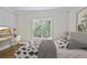 Well-lit bedroom with a dedicated workspace, decorated with cactus motif and a serene ambiance at 963 Bolingbrook Sw Dr, Marietta, GA 30064