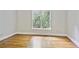 An empty bedroom with hardwood floors and a bright window at 963 Bolingbrook Sw Dr, Marietta, GA 30064