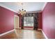 Elegant dining room with hardwood floors, decorative floral wallpaper, and a stylish chandelier at 963 Bolingbrook Sw Dr, Marietta, GA 30064