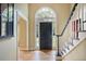 Inviting foyer with hardwood flooring, a grand staircase, and a striking front door with an arched window at 963 Bolingbrook Sw Dr, Marietta, GA 30064