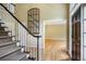 Grand foyer with hardwood floors, staircase with black handrail, and an elegant entrance door at 963 Bolingbrook Sw Dr, Marietta, GA 30064