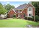 An attractive two-story brick home with a well-maintained front lawn at 963 Bolingbrook Sw Dr, Marietta, GA 30064