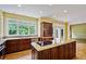 Bright kitchen features granite counters, wood cabinets, and an island with a cooktop at 963 Bolingbrook Sw Dr, Marietta, GA 30064