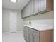 Bright laundry room with marble countertops and modern gray cabinetry for ample storage space at 963 Bolingbrook Sw Dr, Marietta, GA 30064