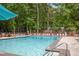 Outdoor community pool surrounded by mature trees and lounge chairs at 963 Bolingbrook Sw Dr, Marietta, GA 30064