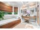 Modern bathroom with a soaking tub, double sink vanity, and woven window shades at 29 Greenland Trce, Atlanta, GA 30342