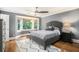 Comfortable bedroom features a cozy bay window, hardwood floors, and a neutral color palette at 29 Greenland Trce, Atlanta, GA 30342