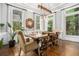 Bright dining room with hardwood floors, a modern light fixture, and large windows overlooking the greenery at 29 Greenland Trce, Atlanta, GA 30342