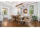 Bright dining room with hardwood floors, a modern light fixture, and large windows overlooking the greenery at 29 Greenland Trce, Atlanta, GA 30342