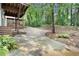 Large driveway next to a lushly landscaped backyard, providing ample parking space and a private setting at 29 Greenland Trce, Atlanta, GA 30342