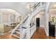 Elegant foyer featuring hardwood floors, a staircase with white railings, and views into the living spaces at 29 Greenland Trce, Atlanta, GA 30342