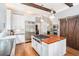 Well-lit kitchen featuring stainless steel appliances, wood island countertop, and farmhouse sink at 29 Greenland Trce, Atlanta, GA 30342