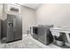 Well-equipped laundry room with modern washer and dryer units and a utility sink at 29 Greenland Trce, Atlanta, GA 30342