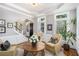 Comfortable living room featuring hardwood floors, stylish armchairs, and views into the foyer and front entry at 29 Greenland Trce, Atlanta, GA 30342