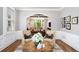 Comfortable living room featuring hardwood floors, stylish armchairs, and views into a sunlit bay window at 29 Greenland Trce, Atlanta, GA 30342