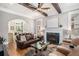 Cozy living room with a fireplace, ceiling fan and hardwood flooring at 29 Greenland Trce, Atlanta, GA 30342