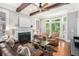 Bright living room with large windows, fireplace, ceiling fan and hardwood flooring at 29 Greenland Trce, Atlanta, GA 30342