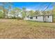 View of the home's backyard with detached garage and landscaping, including an area for gardening at 484 Lorene Sw Dr, Marietta, GA 30060
