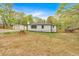 View of the home's backyard with storage and detached garage, landscaping, and fencing at 484 Lorene Sw Dr, Marietta, GA 30060