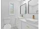 Bright bathroom featuring double vessel sinks, modern gold fixtures, and sleek black framed mirrors at 484 Lorene Sw Dr, Marietta, GA 30060
