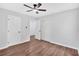 Spacious bedroom with a ceiling fan, hardwood floors, and closet with sliding doors at 484 Lorene Sw Dr, Marietta, GA 30060
