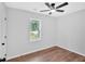 Cozy bedroom with a ceiling fan, a window, and light-colored wood flooring at 484 Lorene Sw Dr, Marietta, GA 30060