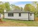 The home features a modern white siding with black trim and neatly trimmed garden beds at 484 Lorene Sw Dr, Marietta, GA 30060