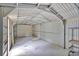 Metal garage interior with roll-up door and shelving at 484 Lorene Sw Dr, Marietta, GA 30060