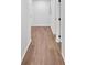 Hallway featuring updated floors, neutral walls, and dark door hardware at 484 Lorene Sw Dr, Marietta, GA 30060