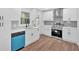Updated kitchen with modern white cabinetry, stainless steel appliances, and a pop of color with blue dishwasher at 484 Lorene Sw Dr, Marietta, GA 30060