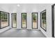 Bright room with gray floor, white walls, and multiple windows with black trim at 484 Lorene Sw Dr, Marietta, GA 30060