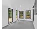 Bright room with gray floor, white walls, and multiple windows with black trim at 484 Lorene Sw Dr, Marietta, GA 30060