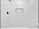 Elegant shower with large marble-look tiles, a niche for storage, and black fixtures at 484 Lorene Sw Dr, Marietta, GA 30060