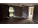 A bedroom showcasing neutral walls, wood floors, ceiling fan, and an adjacent room at 700 W College St, Bowdon, GA 30108
