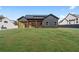Large grassy backyard with a view of the home's exterior and covered patio, perfect for outdoor relaxation and activities at 859 N Bay Overlook, Villa Rica, GA 30180