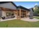Home exterior showcasing a covered outdoor seating and kitchen area, and a landscaped backyard at 859 N Bay Overlook, Villa Rica, GA 30180