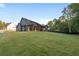 Expansive backyard view, showcasing the well-manicured lawn, modern home exterior, and inviting outdoor patio at 859 N Bay Overlook, Villa Rica, GA 30180