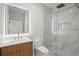 Modern bathroom featuring a glass-enclosed shower, illuminated vanity mirror, and wood grain cabinet at 859 N Bay Overlook, Villa Rica, GA 30180