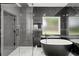 Contemporary bathroom featuring a soaking tub and luxurious glass shower at 859 N Bay Overlook, Villa Rica, GA 30180