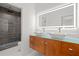 Modern bathroom with double sinks, custom wood cabinets, and tile shower at 859 N Bay Overlook, Villa Rica, GA 30180