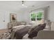 Bright bedroom featuring neutral tones, ceiling fan, and a large window with views of lush greenery at 859 N Bay Overlook, Villa Rica, GA 30180