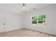 Bright bedroom featuring light-colored walls, wood floors, a ceiling fan and a large window at 859 N Bay Overlook, Villa Rica, GA 30180