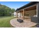 Enjoy outdoor entertaining on this covered patio with a built-in grill, outdoor fire pit and a lush green lawn at 859 N Bay Overlook, Villa Rica, GA 30180