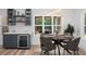Cozy dining area with a modern light fixture and large windows overlooking the outdoor patio at 859 N Bay Overlook, Villa Rica, GA 30180