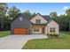 Charming home featuring a mix of brick and board-and-batten siding, and a well-manicured lawn at 859 N Bay Overlook, Villa Rica, GA 30180