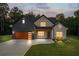 Charming home featuring a mix of brick and board-and-batten siding, and a well-manicured lawn at 859 N Bay Overlook, Villa Rica, GA 30180