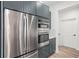 Stainless steel refrigerator and oven appliance package against blue kitchen cabinets at 859 N Bay Overlook, Villa Rica, GA 30180