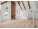 Spacious living room featuring vaulted ceilings, exposed beams, modern fireplace, and light-colored flooring at 859 N Bay Overlook, Villa Rica, GA 30180
